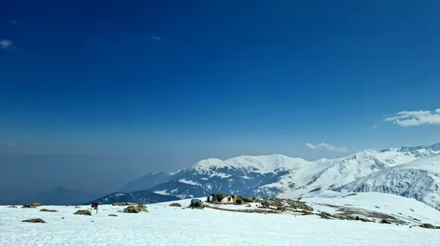 Deep snow and blue sky on the slopes above Gulmarg