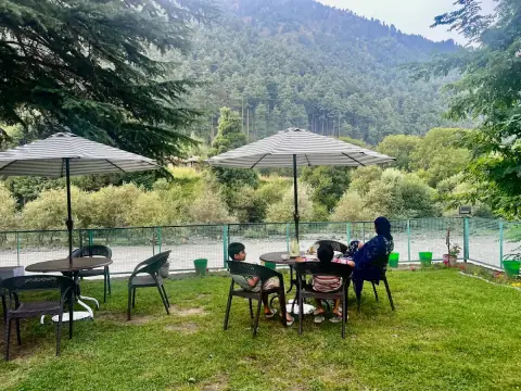 Garden seating by the river at Riverside Cottage, Pahalgam